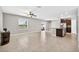 Open-concept living space with tile flooring connecting to the kitchen, island, and dining area at 13324 Willow Bluestar Loop, Riverview, FL 33579
