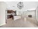 A modern open floorplan features a kitchen with dark wood cabinets and an adjacent living and dining area at 13324 Willow Bluestar Loop, Riverview, FL 33579