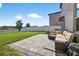 Inviting outdoor patio area with stone pavers and a comfortable seating arrangement at 13324 Willow Bluestar Loop, Riverview, FL 33579