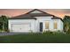 Charming single-story home with a two-car garage, a landscaped yard, and a modern architectural design at 13682 Canyon Ridge Rd, Spring Hill, FL 34610