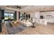 Open-concept living area with natural light, wood floors, and a seamless flow to the kitchen and dining area at 13690 Canyone Ridge Rd, Spring Hill, FL 34610