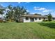 Home's backyard featuring a lush lawn and a patio, perfect for outdoor relaxation at 1617 Leland Dr, Sun City Center, FL 33573