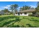 Home's backyard featuring a lush lawn and a patio, perfect for outdoor relaxation at 1617 Leland Dr, Sun City Center, FL 33573