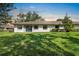 Home's backyard featuring a lush lawn and a patio, perfect for outdoor relaxation at 1617 Leland Dr, Sun City Center, FL 33573