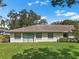 Home's backyard featuring a lush lawn and a patio, perfect for outdoor relaxation at 1617 Leland Dr, Sun City Center, FL 33573