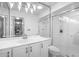 Bright bathroom featuring white cabinets, a glass shower, and decorative lighting at 1617 Leland Dr, Sun City Center, FL 33573