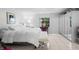 Bright bedroom featuring a comfortable bed, mirrored wardrobe, and tiled floors at 1617 Leland Dr, Sun City Center, FL 33573