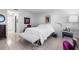Bright bedroom with white walls, tiled floors, and comfortable king-sized bed at 1617 Leland Dr, Sun City Center, FL 33573