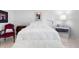 Bright bedroom featuring white walls, tile floors, and a comfortable king-sized bed at 1617 Leland Dr, Sun City Center, FL 33573