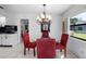 Dining Area with chandelier and red chairs at 1617 Leland Dr, Sun City Center, FL 33573
