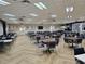 A spacious community dining room is furnished with tables and chairs for communal dining and socializing at 1617 Leland Dr, Sun City Center, FL 33573