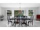 Bright dining room features a chandelier and a view of the golf course at 1617 Leland Dr, Sun City Center, FL 33573