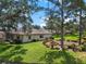 Cozy home exterior showcasing lush landscaping and manicured lawn in a serene neighborhood at 1617 Leland Dr, Sun City Center, FL 33573