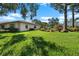 Inviting home exterior featuring a well-manicured lawn and attractive landscaping at 1617 Leland Dr, Sun City Center, FL 33573