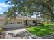 Charming single-story home featuring a well-maintained lawn, an attached garage, and beautiful landscaping at 1617 Leland Dr, Sun City Center, FL 33573