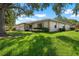 Well-kept single-story home featuring a front yard with lush greenery and an attached garage at 1617 Leland Dr, Sun City Center, FL 33573