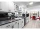 Bright kitchen with white cabinets, black hardware, and tile flooring at 1617 Leland Dr, Sun City Center, FL 33573