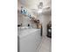 Practical laundry room featuring appliances and storage shelving at 1617 Leland Dr, Sun City Center, FL 33573