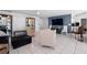 Well-lit living space with a modern TV and tile floors at 1617 Leland Dr, Sun City Center, FL 33573
