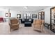 Bright living room with neutral tones, comfortable seating, and a decorative display cabinet at 1617 Leland Dr, Sun City Center, FL 33573