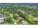 Aerial view of home with mature landscaping, tennis court and close proximity to local waterways at 1628 Long Bow Ln, Clearwater, FL 33764