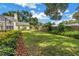 Well-maintained backyard with lush lawn and privacy landscaping creating a serene and private outdoor area at 1628 Long Bow Ln, Clearwater, FL 33764