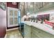 Elegant bar area with wine storage, marble countertops, and a view from the window at 1628 Long Bow Ln, Clearwater, FL 33764
