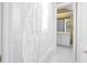 View of the bathroom shower and tub with the white shower curtain pulled to the side at 1628 Long Bow Ln, Clearwater, FL 33764