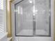 Bright bathroom with a tub-shower combo with glass doors and a showerhead at 1628 Long Bow Ln, Clearwater, FL 33764