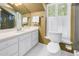 Bathroom featuring white vanity, mirror, shutters, and updated sink at 1628 Long Bow Ln, Clearwater, FL 33764