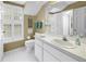 Bright bathroom featuring a white vanity, square tiles, and plantation shutters for a clean and modern aesthetic at 1628 Long Bow Ln, Clearwater, FL 33764