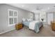 Cozy bedroom with a ceiling fan, complemented by a floral bed skirt and woven bedside table at 1628 Long Bow Ln, Clearwater, FL 33764