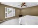 Bedroom featuring a ceiling fan, white shutters, and a window overlooking the yard at 1628 Long Bow Ln, Clearwater, FL 33764