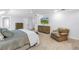 Spacious bedroom featuring light gray walls, carpet, TV, ceiling fan, and ensuite bathroom at 1628 Long Bow Ln, Clearwater, FL 33764