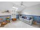 room offers a comfy couch, a rocking chair, and decoratively themed wallpaper at 1628 Long Bow Ln, Clearwater, FL 33764