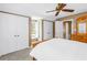 Bedroom features neutral carpeting, a ceiling fan, and an abundance of closet space at 1628 Long Bow Ln, Clearwater, FL 33764