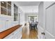 Bright dining room with hardwood floors, classic wainscotting, and an adjacent butler's pantry at 1628 Long Bow Ln, Clearwater, FL 33764