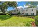Charming two-story home with manicured lawn, lush green landscaping, and inviting curb appeal at 1628 Long Bow Ln, Clearwater, FL 33764