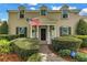 Welcoming front entrance with an American flag, lush landscaping and a brick-paved walkway at 1628 Long Bow Ln, Clearwater, FL 33764