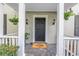 Inviting front entrance with classic black door, stylish sconces, and charming decor at 1628 Long Bow Ln, Clearwater, FL 33764