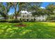 Stately home with lush front lawn and manicured landscaping providing curb appeal and a welcoming ambiance at 1628 Long Bow Ln, Clearwater, FL 33764