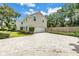 Beautiful home featuring a large garage, brick-paved driveway, and manicured landscaping at 1628 Long Bow Ln, Clearwater, FL 33764