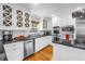 Bright kitchen boasts white cabinets, stainless steel appliances, and granite countertops at 1628 Long Bow Ln, Clearwater, FL 33764