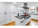 Bright kitchen featuring large pantry, island with cooktop, and eat in kitchen at 1628 Long Bow Ln, Clearwater, FL 33764