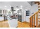 Gourmet kitchen boasts an island, white cabinets, stainless steel appliances, and stairs at 1628 Long Bow Ln, Clearwater, FL 33764