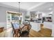 Open-concept kitchen and dining area with breakfast nook, stainless steel appliances, and granite countertops at 1628 Long Bow Ln, Clearwater, FL 33764