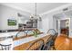 Eat-in kitchen area with stainless steel appliances, black countertops, and hardwood floors at 1628 Long Bow Ln, Clearwater, FL 33764