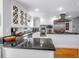 Modern kitchen with stainless steel appliances, white cabinetry, and a dark countertop at 1628 Long Bow Ln, Clearwater, FL 33764