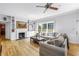 Inviting living room showcases a fireplace, comfortable seating, and large windows with backyard views at 1628 Long Bow Ln, Clearwater, FL 33764