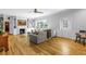 Cozy living room with built-in bookshelves, fireplace, large windows, and hardwood floors at 1628 Long Bow Ln, Clearwater, FL 33764